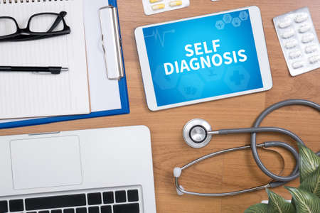 SELF DIAGNOSIS Professional doctor use computer and medical equipment all around, desktop top viewの写真素材