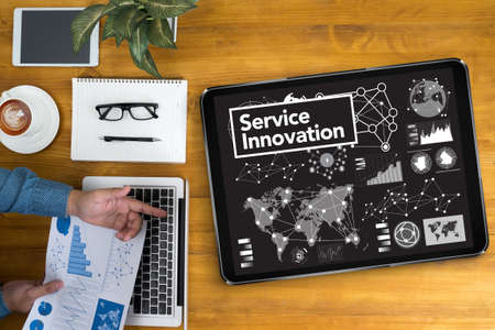 Service Innovation  Businessman working at office desk and using computer and objects, coffee, top...