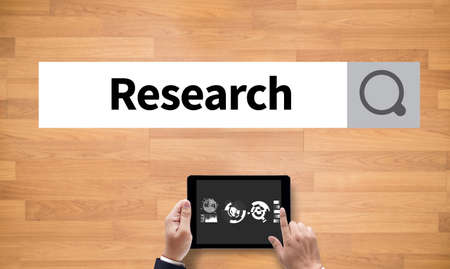 Business Research Data Economy, on the tablet pc screen held by businessman hands - online, top viewの写真素材