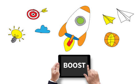 BOOST YOUR BUSINESS, on the tablet pc screen held by businessman hands - online, top viewの写真素材