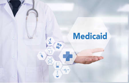 Medicaid Medicine doctor hand working  Professional doctor use computer and medical equipment all around, desktop top viewの写真素材