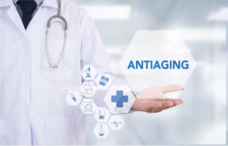 ANTIAGING Medicine doctor hand working  Professional doctor use computer and medical equipment all around, desktop top viewの写真素材