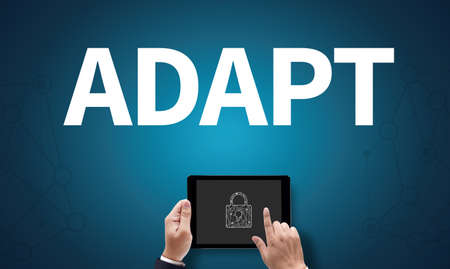ADAPT, on the tablet pc screen held by businessman hands - online, top viewの写真素材