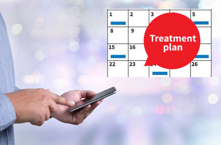 Treatment plan person holding a smartphone on blurred cityscape backgroundの写真素材