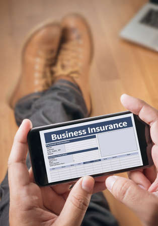 Business Insurance Management work Business Thoughtful male person looking to the digital phone screen,Silhouette top computer and handの写真素材