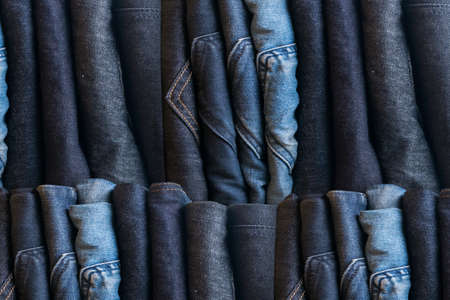 Blue jeans on a brown wooden background and Blue jeans denim Collection jeans stackedの写真素材