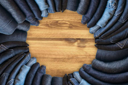Blue jeans on a brown wooden background and Blue jeans denim Collection jeans stackedの写真素材
