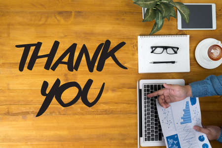 THANK YOU Businessman working at office desk and using computer and objects, coffee, top viewの写真素材