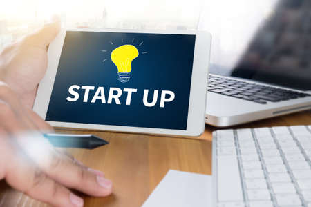 business man hand working on laptop computer start up, working with new startup project sun flare effectの写真素材