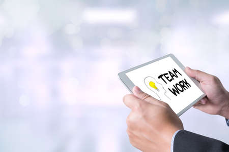 teamwork Businessman holding a tablet computer on blurred city backgroundの写真素材