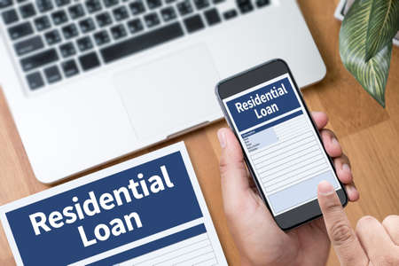 Residential Loan Purchase Agreement to Living Estate Mortgage loading real estate property  Thoughtful male person looking to the digital phone screen,Silhouette top computer and handの写真素材