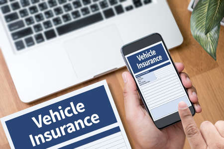 Form Document Vehicle Insurance Claim  Thoughtful male person looking to the digital phone screen,Silhouette top computer and handの写真素材