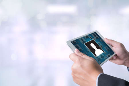 RESOURCES Human Resources Interview Recruitment Job  Businessman holding a tablet computer on blurred city backgroundの写真素材