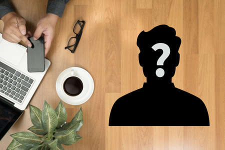 hand phone, who is calling Hipster wooden desktop with laptop, office accessories, flat lay top viewの写真素材