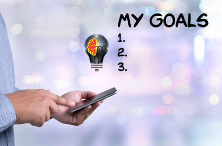 person holding a smartphone on blurred cityscape backgroundの写真素材