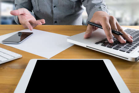 man hand holding smartphone device and  technology , businessman working with modern devices, digital tablet computer and mobile phone.の写真素材