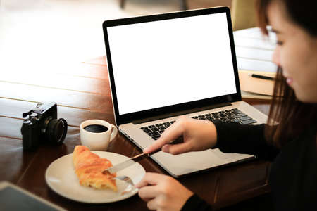 woman of business man hand working on laptop computer on wooden desk Laptop with blank screen on table.の写真素材