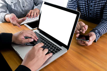 man of business man hand working on laptop computer on wooden desk Laptop with blank screen on table.の写真素材
