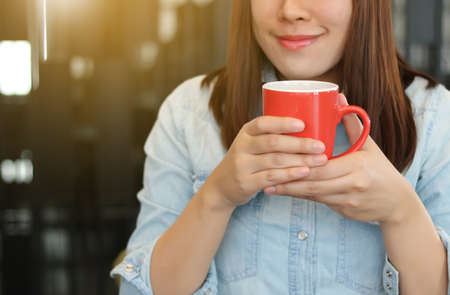 morning coffee. Woman drinking coffee enjoying in the sun, outdoor in sunlight lightの写真素材