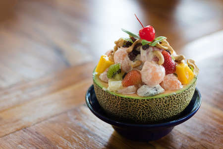 healthy fresh Delicious fruits salad in plate on table close-up and copy spaceの写真素材