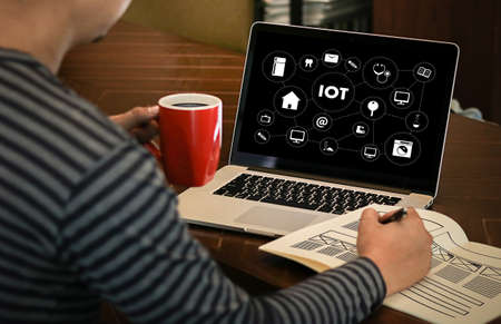 IOT business man hand working and internet of things (IoT) word diagram as conceptの写真素材