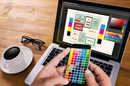 Creative Designer Graphic at work. Color swatch samples, Illustrator Graphic designer working digital tablet and computerの写真素材
