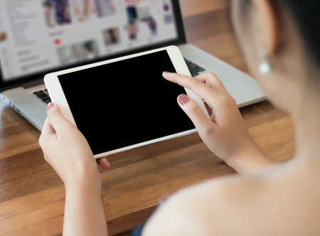 woman of business  hand working on laptop computer on wooden desk Laptop with blank screen on table.の写真素材