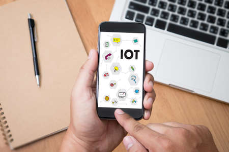 IOT business man hand working and internet of things (IoT) word diagram as conceptの写真素材