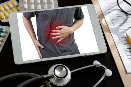 Ache man suffering with back pain backache Pain reliefの写真素材