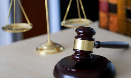 Gavel and legal Judge gavel scales of justice and law working on tableの写真素材