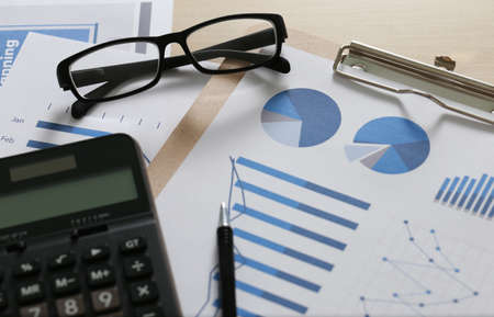 Checking financial reports paperwork and Business  Teamwork on Preparing report Blue graphs  glassesの写真素材