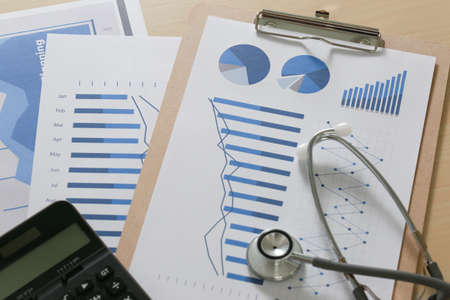 financial report chart and calculator Medical Report and stethoscopeの写真素材