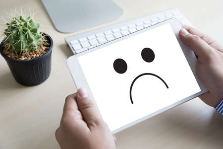 Depressive emotions concept,   smiley face emoticon printed depression and sad pessimistic face sadnessのeditorial素材