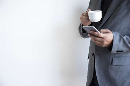 man use phone happy and  smile with coffee and White background copy spaceの写真素材