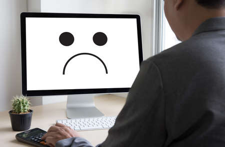 Depressive emotions concept,   smiley face emoticon printed depression and sad pessimistic face sadnessの写真素材