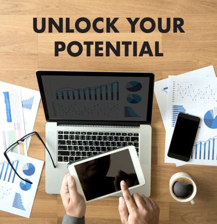 UNLOCK YOUR POTENTIAL  businessman hand working concept for GROWTHの写真素材