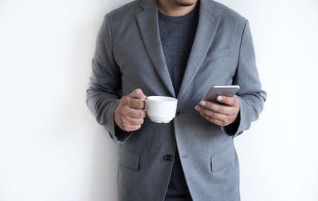 Man use phone happy and  smile with coffee and White background copy spaceの写真素材