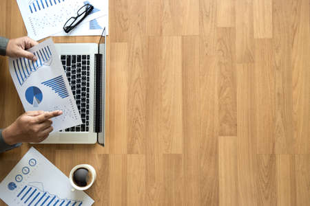 Top view man used of laptop  hands on a wooden desktop and copy spaceの写真素材