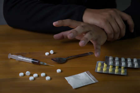 man substance dependence medication Drug syringe and cooked heroinの写真素材