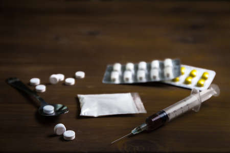 man substance dependence medication Drug syringe and cooked heroinの写真素材