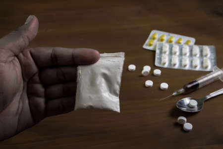 man substance dependence medication Drug syringe and cooked heroin