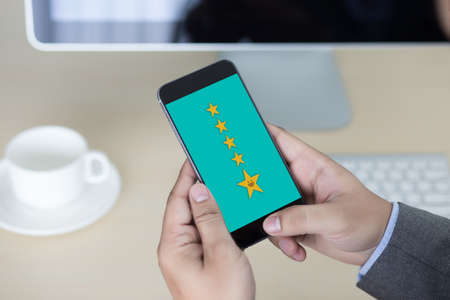 pressing smiley face emoticon The Customer Service Target Business Customer review give a five starの写真素材