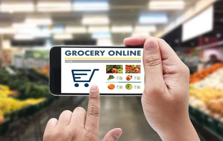 Grocery shopping of vegetable and healthy food via the smart phone online supermarket conceptの写真素材