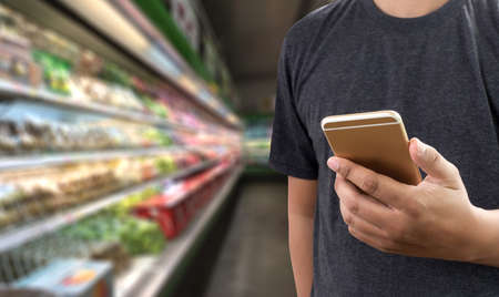 Grocery shopping for vegetable and healthy food via smartphone online supermarket concept
