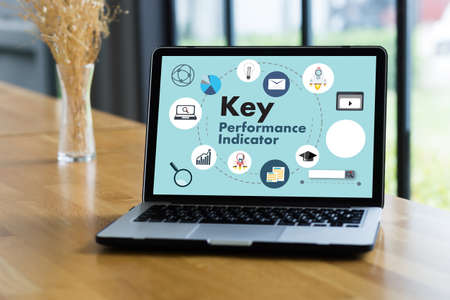 KPI acronym (Key Performance Indicator) Business team hands at work with financial reports and a...