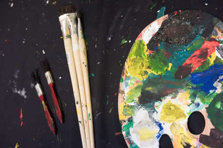 Used paint brushes with watercolor set Old paint cans and colors colorful and paint brush.の写真素材