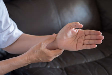 Elderly woman suffering from pain From Rheumatoid Arthritisの写真素材