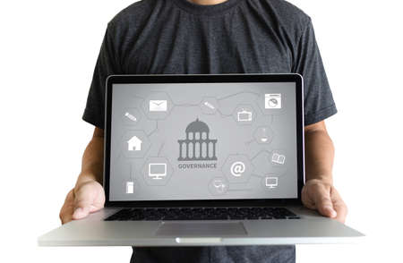 GOVERNANCE and building, Authority Computing Computer Laptop with screen on table Silhouette and filter sunの写真素材