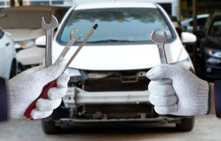Mechanic repairing a car  in garage  Auto repair car engineの写真素材
