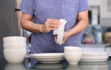 Woman Cleaning product concept wiping dishware cleaner in home and kitchenの写真素材